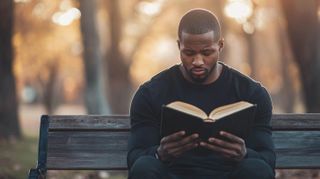 Man on Bench Reading Bible