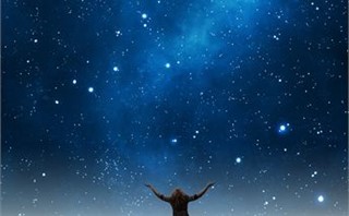 Woman praising under night sky