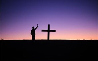 by the cross
