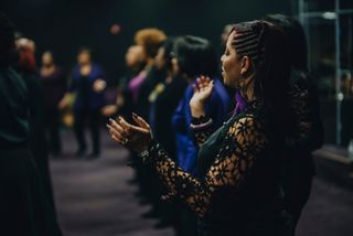 Woman claps at church