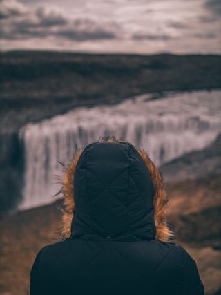 Woman Looking at Waterfall